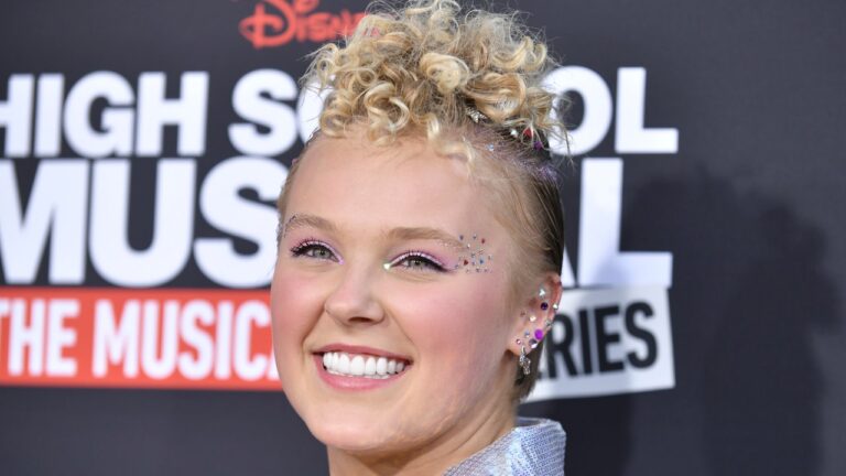 Jojo Siwa’s Hair Is a Rainbow Eruption Doused In Holographic Hair Tinsel and All-Over Gems – See Picture