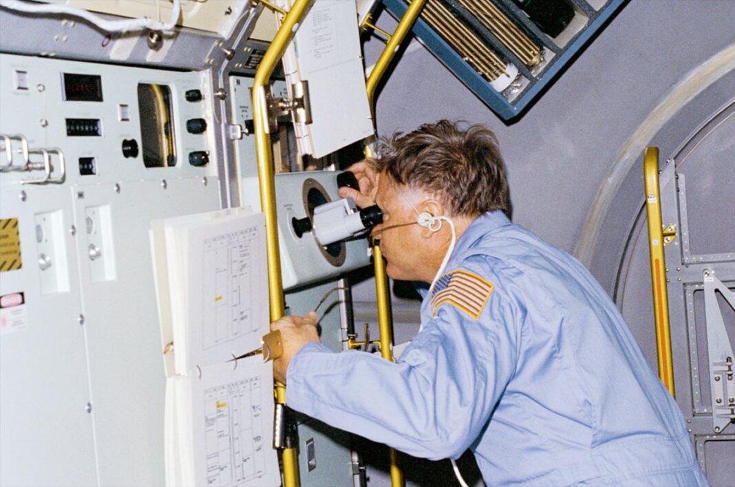 NASA astronaut Don Lind observes crystals being grown on board the Spacelab 3 science module during space shuttle Challenger