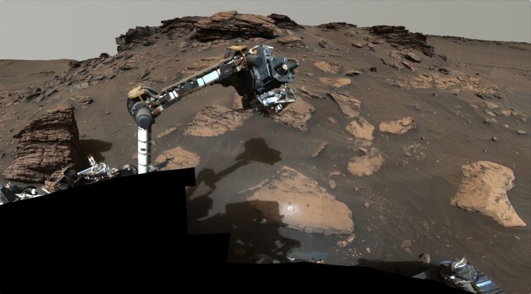 NASA’s Perseverance rover puts its robotic arm to work around a rocky outcrop called “Skinner Ridge” in Mars’ Jezero Crater. Composed of multiple images, this mosaic shows layered sedimentary rocks in the face of a cliff in the delta, as well as one of the locations where the rover abraded a circular patch to analyze a rock’s composition.