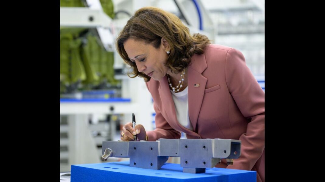 Vice President Kamala Harris signs a bracket that will fly to the moon on the Artemis 3 Orion spacecraft while touring NASA