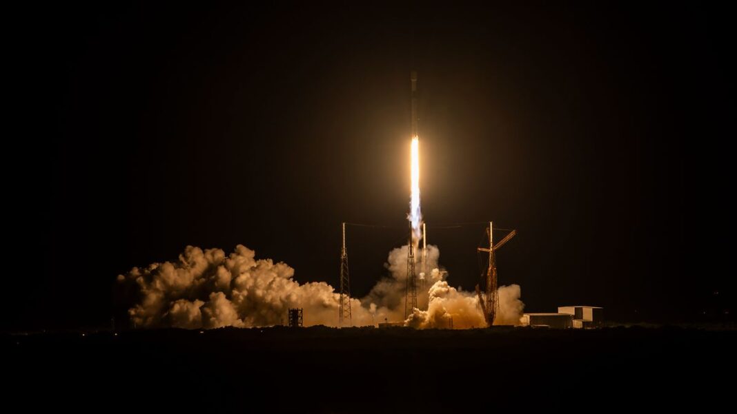 a rocket launches into a dark night sky.