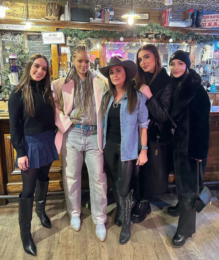 Rihanna Posed with Kyle Richards and Family in a $4,500 Cream YSL Blazer, a $3,500 Grey  Bottega Cashmere Hoodie, $855 Light Washed Balenciaga Jeans, and $575 Blue Suede Kemo Sabe Boots