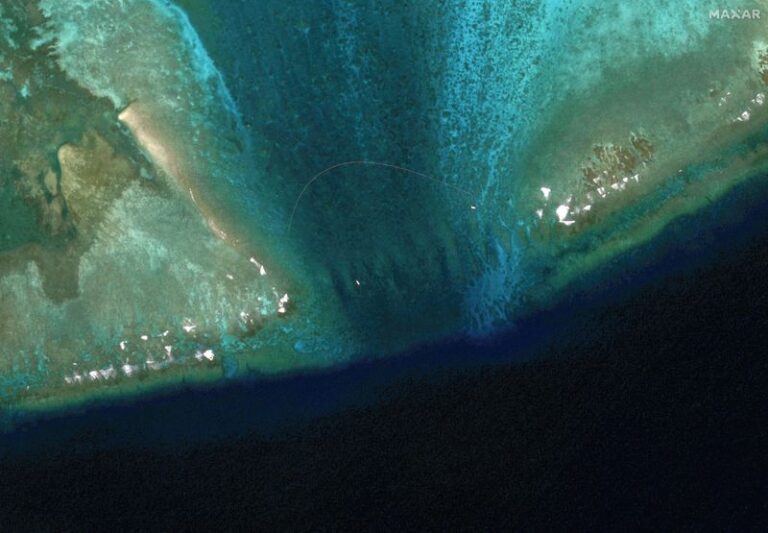 Exclusive-Satellite images reveal floating barrier at mouth of disputed atoll in South China Sea